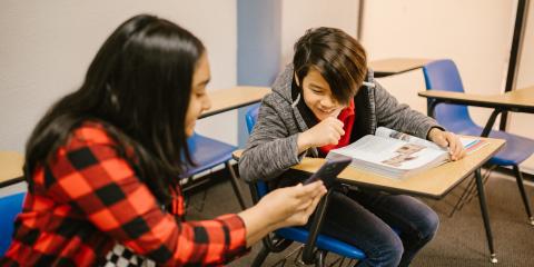 Pexels stock photography. Two kids looking at a phone.