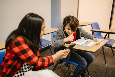 Pexels stock photography. Two kids looking at a phone.